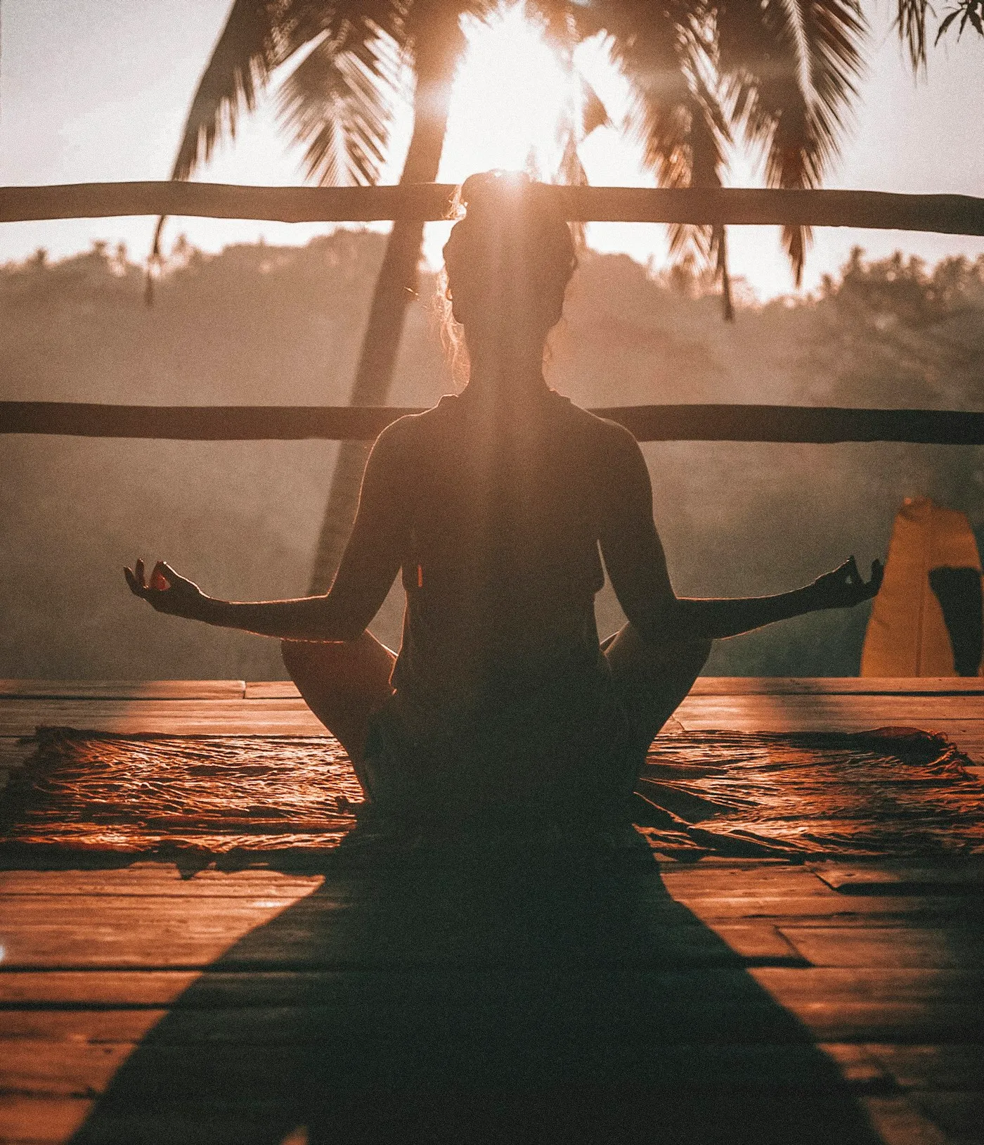 Woman meditating in a calm, sunlit room as part of a daily mental health routine